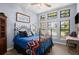 Comfortable bedroom featuring large windows with natural light and cozy decor at 36846 Perry Ct, Dade City, FL 33525