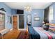 Charming bedroom features a chandelier, natural light, and hardwood floors at 36846 Perry Ct, Dade City, FL 33525