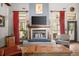 Cozy fireplace with wood mantel, tile surround, and modern TV at 36846 Perry Ct, Dade City, FL 33525