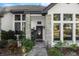 Inviting front entrance with stone accents and manicured garden bed featuring lush plants at 36846 Perry Ct, Dade City, FL 33525