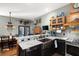 Well-appointed kitchen with breakfast bar and modern appliances, plus dining area in the background at 36846 Perry Ct, Dade City, FL 33525