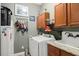 Functional laundry room with washer, dryer, cabinets, sink, and ample storage space at 36846 Perry Ct, Dade City, FL 33525