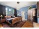 Spacious main bedroom features wood floors, ample windows, and elegant decor at 36846 Perry Ct, Dade City, FL 33525