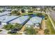 Stunning aerial view of coastal homes near a picturesque pond and lush landscaping, showcasing a desirable community setting at 6412 Coquina Island Cv, Apollo Beach, FL 33572