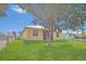 A charming home with a large, lush backyard and a partial view of a neighboring house at 6412 Coquina Island Cv, Apollo Beach, FL 33572