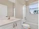 Well-lit bathroom with a bathtub, shower, and a white vanity with modern fixtures at 6412 Coquina Island Cv, Apollo Beach, FL 33572
