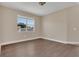 Comfortable bedroom featuring hardwood floors, natural light, and neutral-toned walls at 6412 Coquina Island Cv, Apollo Beach, FL 33572
