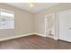 Cozy bedroom with hardwood floors, a ceiling fan, and access to an ensuite bathroom at 6412 Coquina Island Cv, Apollo Beach, FL 33572