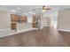 Spacious kitchen with stainless steel appliances, breakfast bar, and hardwood flooring at 6412 Coquina Island Cv, Apollo Beach, FL 33572