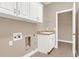 Practical laundry room with storage cabinets, a sink, and washer/dryer hookups at 6412 Coquina Island Cv, Apollo Beach, FL 33572