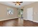 Bright living room with hardwood floors, fan, and sliding glass doors to a patio at 6412 Coquina Island Cv, Apollo Beach, FL 33572