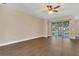 Inviting living room featuring hardwood floors, sliding glass doors and a view of the water at 6412 Coquina Island Cv, Apollo Beach, FL 33572