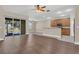 Open-concept living room with hardwood floors flowing into the kitchen area at 6412 Coquina Island Cv, Apollo Beach, FL 33572