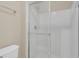 Clean white tiled shower with glass door and chrome fixtures in the bathroom at 806 Rocky Mountain Ct, Valrico, FL 33594