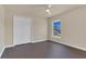 This bedroom features dark hardwood floors, natural light, and a spacious closet for organized storage at 806 Rocky Mountain Ct, Valrico, FL 33594