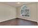 A bedroom with wood floors, natural light from a large window, and a vaulted ceiling offers comfortable living at 806 Rocky Mountain Ct, Valrico, FL 33594