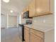 Well-lit kitchen includes modern appliances, light cabinetry, and a view of the connected laundry room at 806 Rocky Mountain Ct, Valrico, FL 33594