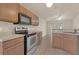 Modern kitchen featuring oven and microwave with ample counter space and seamless transition to the dining area at 806 Rocky Mountain Ct, Valrico, FL 33594