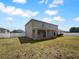 Large backyard with a covered patio and a white privacy fence at 10768 Carloway Hills Dr, Wimauma, FL 33598