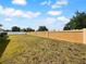 Backyard featuring a large, flat grassy area and a tall privacy fence at 10768 Carloway Hills Dr, Wimauma, FL 33598