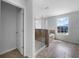 Spacious bathroom with tiled floors, separate shower and soaking tub, and bright window at 10768 Carloway Hills Dr, Wimauma, FL 33598