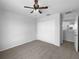 Carpeted bedroom with a ceiling fan and closet at 10768 Carloway Hills Dr, Wimauma, FL 33598