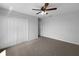 Bedroom featuring neutral walls, carpet flooring, a ceiling fan, and a closet at 10768 Carloway Hills Dr, Wimauma, FL 33598