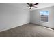 Bedroom featuring neutral walls, carpet flooring, a ceiling fan, and a window at 10768 Carloway Hills Dr, Wimauma, FL 33598