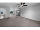 Bedroom features neutral carpet, ceiling fan, and view of bathroom at 10768 Carloway Hills Dr, Wimauma, FL 33598
