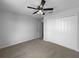 Bedroom with carpet flooring, ceiling fan and closet at 10768 Carloway Hills Dr, Wimauma, FL 33598
