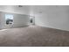 Large open bonus room with two windows and plush carpeting at 10768 Carloway Hills Dr, Wimauma, FL 33598