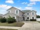 Charming two-story home with a well-manicured lawn, an attached garage, and inviting curb appeal at 10768 Carloway Hills Dr, Wimauma, FL 33598