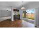 Bright kitchen flows into eating area featuring hardwood floors and sliding glass door to the backyard at 10768 Carloway Hills Dr, Wimauma, FL 33598