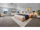 This main bedroom features large windows for natural light, modern furnishings, and neutral tones at 10768 Carloway Hills Dr, Wimauma, FL 33598