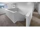 Bright stairway with neutral carpet leads to the upper level in this well-lit home at 10768 Carloway Hills Dr, Wimauma, FL 33598