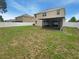 Lush backyard with green grass, a screen enclosed porch, and a privacy fence, ideal for outdoor relaxation at 5383 Magdalene Way, Zephyrhills, FL 33541