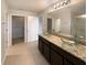 Elegant bathroom with a double vanity, modern fixtures, and a glass-enclosed shower at 5383 Magdalene Way, Zephyrhills, FL 33541