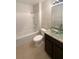 Bright bathroom featuring a tub-shower combo and granite topped vanity with a stylish glass bowl sink at 5383 Magdalene Way, Zephyrhills, FL 33541