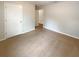 Bedroom with neutral walls, neutral carpeting and two doors, showcasing a clean and versatile space at 5383 Magdalene Way, Zephyrhills, FL 33541