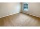 Bright bedroom featuring neutral walls and carpet, a sunny window, and a spacious area at 5383 Magdalene Way, Zephyrhills, FL 33541