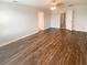 Bedroom showcasing wood flooring, neutral walls and an open doorway at 5383 Magdalene Way, Zephyrhills, FL 33541