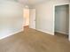 Spacious bedroom featuring neutral carpeting, closet, and a crisp, neutral color palette throughout at 5383 Magdalene Way, Zephyrhills, FL 33541