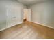 Neutral bedroom with tan carpet, double door closet and white door to the hallway at 5383 Magdalene Way, Zephyrhills, FL 33541