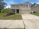 Charming two-story home with a well-maintained lawn and a two car garage at 5383 Magdalene Way, Zephyrhills, FL 33541