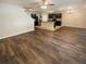 Open concept living room and kitchen featuring sleek dark cabinets and a stainless steel refrigerator at 5383 Magdalene Way, Zephyrhills, FL 33541