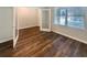 Versatile office space with glass french doors, wood-look flooring, and a large window for natural light at 5383 Magdalene Way, Zephyrhills, FL 33541