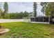 Expansive backyard featuring a screened patio, and plenty of green space for outdoor activities at 5651 Kelly N Dr, St Petersburg, FL 33703