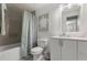 Bathroom with tub shower, vanity, and decorative turtle art at 5651 Kelly N Dr, St Petersburg, FL 33703