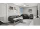 Relaxing bonus room is furnished with a gray sofa, beanbag chair, and natural lighting at 5651 Kelly N Dr, St Petersburg, FL 33703