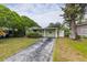 Single-story home featuring a well-maintained lawn, driveway, and mature landscaping at 5651 Kelly N Dr, St Petersburg, FL 33703